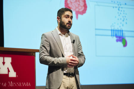 Aryan Shekarabi presenting research.