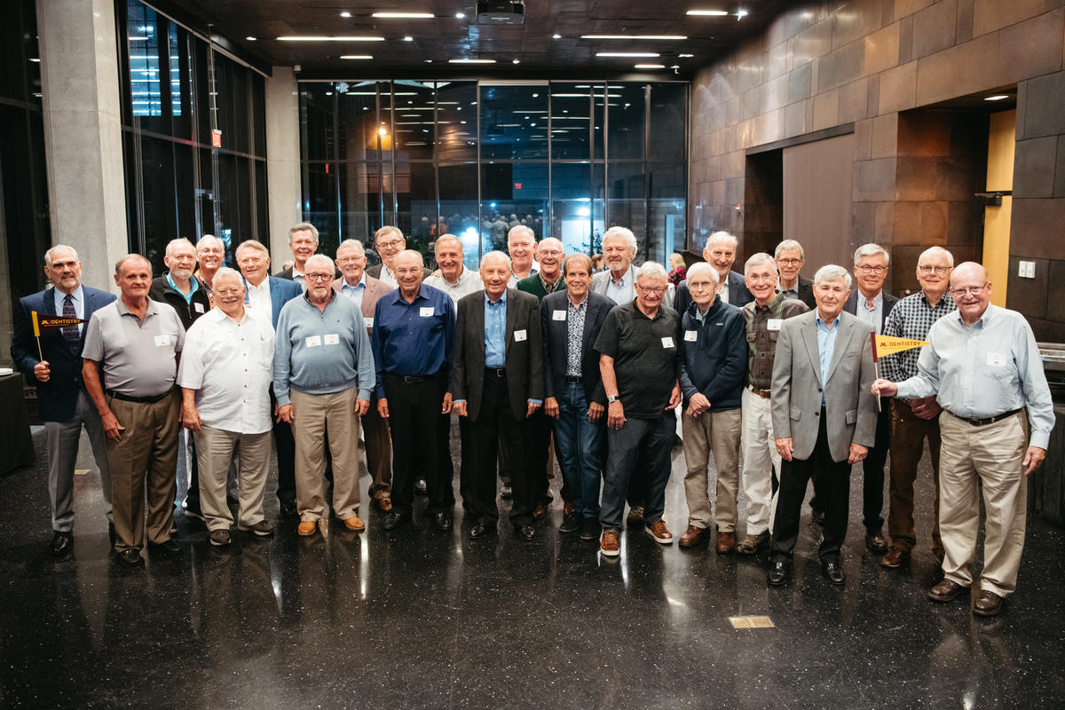 a group photo of 26 retired male dentists at Alumni Weekend 2023