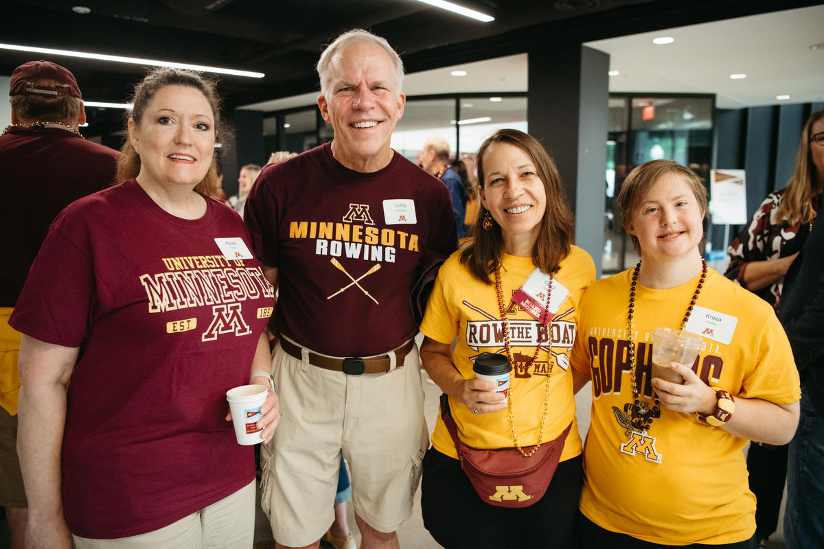 four attendees to Alumni Weekend 2023 wearing University of Minnesota athletics tee shirts with Row the Boat