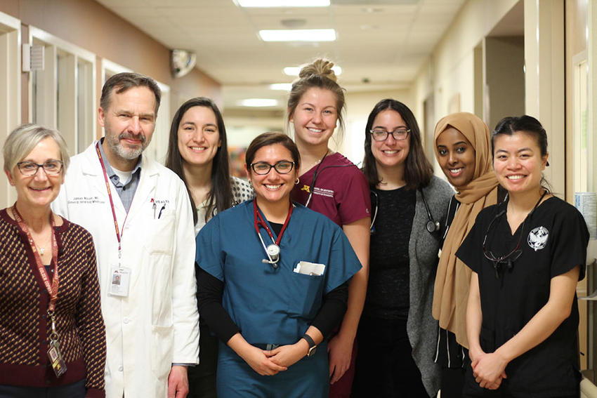 Dental hygiene student Kabrie Weber (center back) and dental therapy student Phonsuda Chanthavisouk (far right) make rounds at U of M Medical Center with their medical and pharmacy counterparts. Cyndee Stull (far left) coordinates the program. 