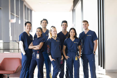 group of racially diverse dental students in scrubs